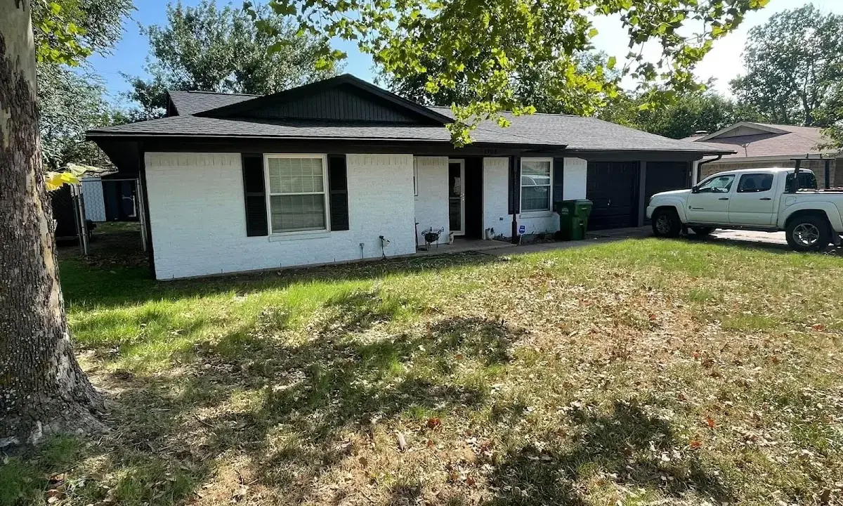 Professional roofing crew working on a residential roof in Gautier